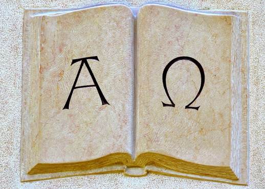 Alpha and Omega symbols written on pages of blank book
